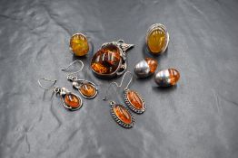 An assortment of silver and white metal amber set jewellery, comprising a large pendant in a