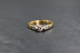 An 18ct gold diamond set solitaire ring, the central round brilliant cut diamond measuring