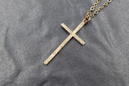 A 9ct gold cross pendant, having scroll decoration, marked 375, on a 9ct gold chain, 4.2g