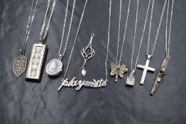Eight silver pendants with chains and one loose white metal pendant, all of various designs
