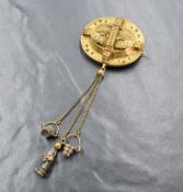 An antique yellow metal brooch, of oval form having decorative floral and bead work with three chain