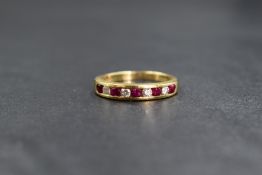 An 18ct ruby and diamond set half eternity band, the five round brilliant cut rubies interspersed