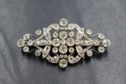 An early 20th century white metal diamond set brooch, the bezel set old cushion, round and