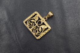 An Egyptian 18ct gold pendant, of rectangular form having a pierced Ankh flanked by two lotus
