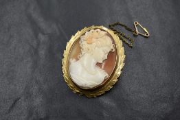 A 9ct gold mounted cameo brooch, the cameo depicting a maiden in profile, in a bezel setting with