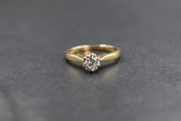 Am 18ct gold diamond set solitaire, the round brilliant cut diamond measuring approximately 0.