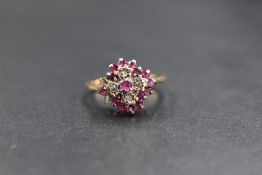 A 9ct ruby and diamond set cluster ring, the central round cut ruby in an illusion diamond chip