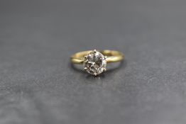 An 18ct gold diamond solitaire ring, the diamond being approx 1.28ct in a raised six claw set