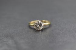 An 18ct gold diamond solitaire ring, the diamond being approx 1.28ct in a raised six claw set