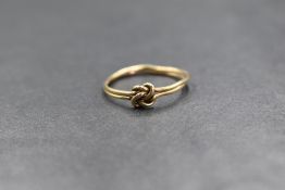 A minimal 9ct gold knot ring, the two gold wires in a decorative knot, marked 9c, ring size N-O, 1.