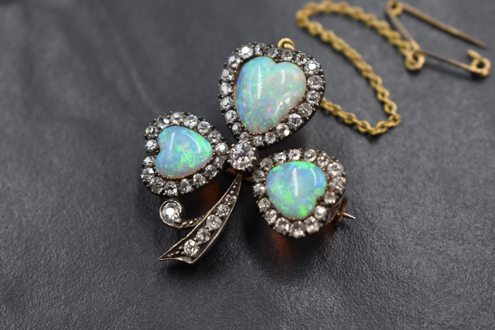A yellow metal presumed gold opal and diamond set clover motif brooch, the three graduated opals - Image 2 of 3