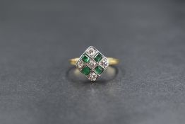 An 18ct gold emerald and diamond set ring, the five round brilliant cut diamonds measuring