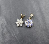 A 9ct gold diamond set floral cluster pendant, the seven round brilliant cut diamonds measuring