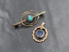 A 9ct gold opal set pendant, the pierced oval pendant having scroll decoration with a an articulated