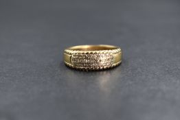A 9ct gold diamond set band, the pave set diamond chips in three rows, marked 375, ring size O-P,