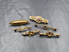 A group of six yellow metal and 9ct gold bar brooches, three being set with pearls and paste, the