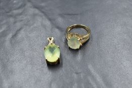 A 9ct gold prehnite ring having a large oval stone in a four claw raised mount to split shoulders on