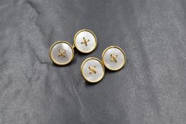A pair of 18ct gold mother-of-pearl set cufflinks, the mother-of-pearl set button motif panels