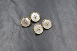 A pair of 18ct gold mother-of-pearl set cufflinks, the mother-of-pearl set button motif panels