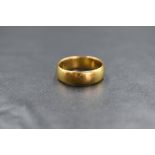 A 22ct gold band, of plain rounded form, marked 22 with hallmarks, ring size N-O, 5.2g