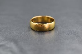 A 22ct gold band, of plain rounded form, marked 22 with hallmarks, ring size N-O, 5.2g