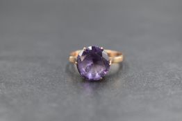 An 18ct gold amethyst set solitaire ring, the round cut amethyst measuring approximately 3.5ct, in