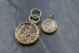 A 19th century yellow metal locket with circular glass and dried heather to centre, the mount chased