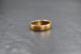 A 22ct gold band, of plain form, marked 22 with hallmarks, ring size P, 4.5g