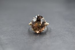 A 9ct gold smoky quartz set ring, the oval cut quartz measuring approximately 15mm x 12mm x 7mm,