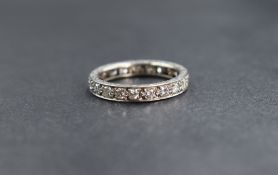A white metal diamond set full eternity ring having twenty one pave set diamonds total approx 1ct,