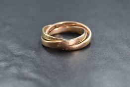 A yellow metal presumed gold Russian wedding ring, comprising three interlocking bands of yellow,
