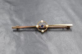 A 15ct gold sapphire and pearl set bar brooch, the central round cut sapphire in an openwork