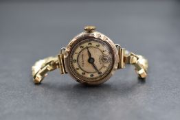 A 9ct gold cased Medana wristwatch, the cream dial having a mother-of-pearl insert, Arabic