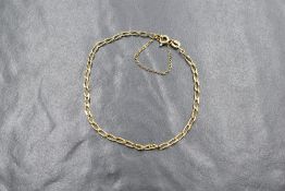 A 9ct gold curb link bracelet with safety chain, approx 1.7g