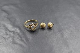 A pair of yellow metal stud earrings having cut decoration, presumed gold and a 9ct gold ring ,