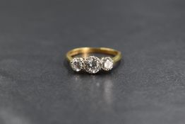 An 18ct gold diamond trilogy ring, the central brilliant cut diamond being approx 0.5ct flanked by