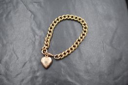 A 9ct gold curb link bracelet, having textured decoration to one side, with a dog clip clasp and