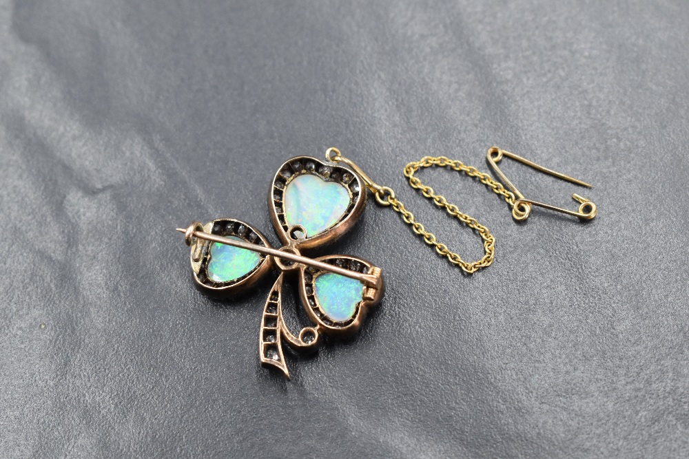 A yellow metal presumed gold opal and diamond set clover motif brooch, the three graduated opals - Image 3 of 3