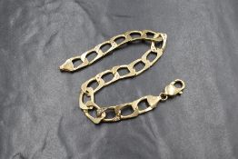 A 9ct gold diamond set curb link bracelet, four of the wide curb links set with diamond chips to the