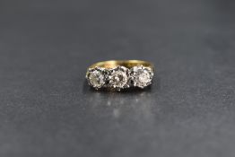 An 18ct gold diamond trilogy ring having three brilliant cut diamonds totalling approx 1ct in an