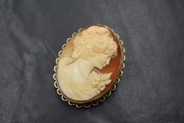 A 9ct gold mounted cameo brooch, of oval form having a maiden in profile, in a bezel mount with