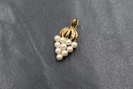 A 9ct gold pearl and diamond set pendant, the bushel of grapes motif pendant having diamond chips