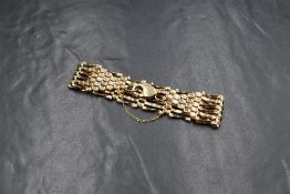 A 9ct gold six bar gate bracelet, having alternate textured and twist bars, with lobster clasp and