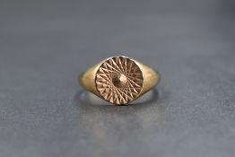 A gent's 9ct gold signet ring having cut decoration to circular plaque, size Y & 7g