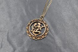 A 9ct gold pendant possibly depicting Virgo zodiac sign on a 9ct rose gold curb link chain, approx