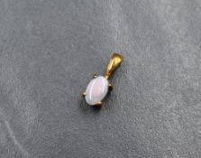 A small 9ct gold mounted black opal cabochon pendant, with retail card for Gems TV, approx 0.5g