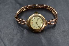 A 9ct gold cased wristwatch, the white dial having Arabic numerals, marked 375, on a gold plated