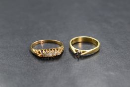 An 18ct gold five diamond ring, having old cut diamonds in a claw set gallery mount (one stone