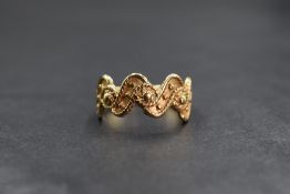 A 9ct gold decorative wave ring, having rope motif and beadwork decoration, marked 375, ring size