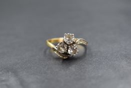 A yellow metal presumed gold diamond set trilogy ring, the three round brilliant cut diamonds